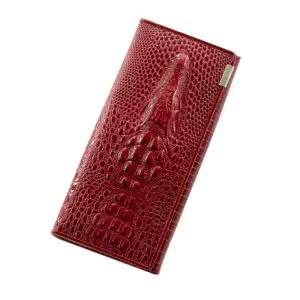 Portefeuille rouge de forme rectangle en peaa de crocodile et dessin en relief d'un alligator sur le dessus.