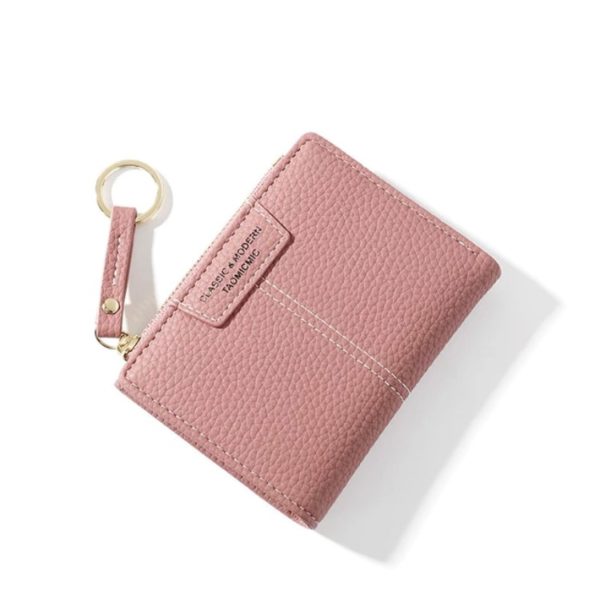 Petit portefeuille rose en simili cuir à l'aspect grainé. Compact, petit, élégant, féminin.